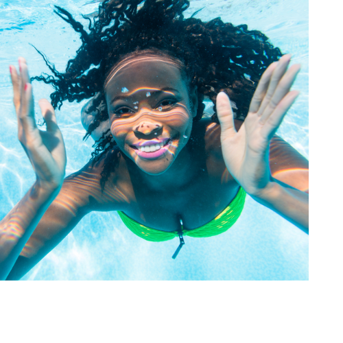 Woman posing in the pool for an underwater photo.