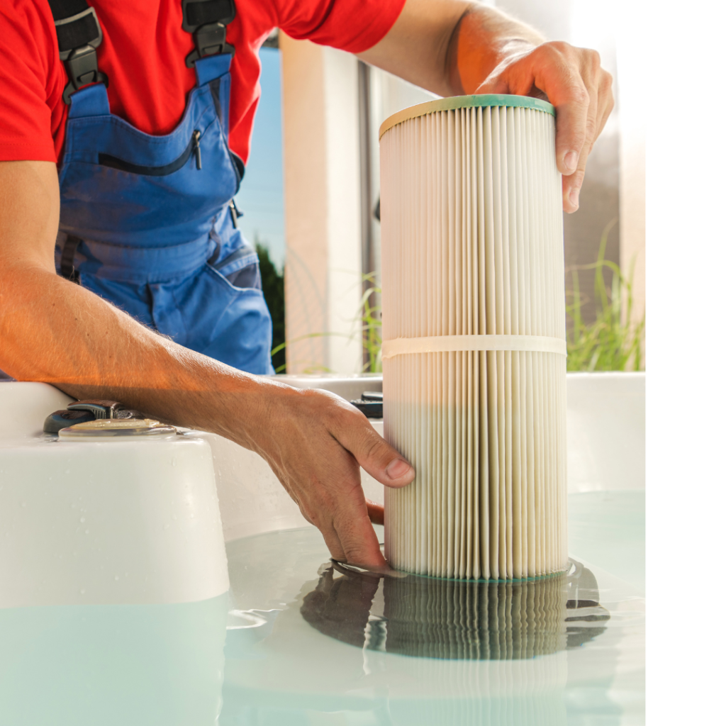 A man in a red t-shirt and blue overalls removes the hot tub's filter