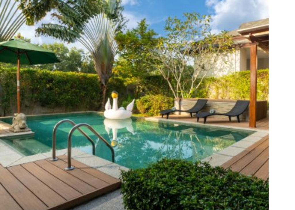 Outdoor pool is surrounded by fun trees and shrubs