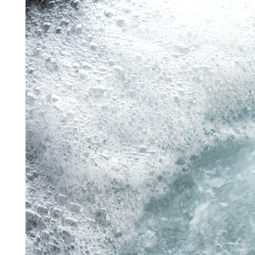 A shot of white, bubbly and foamy swim spa water