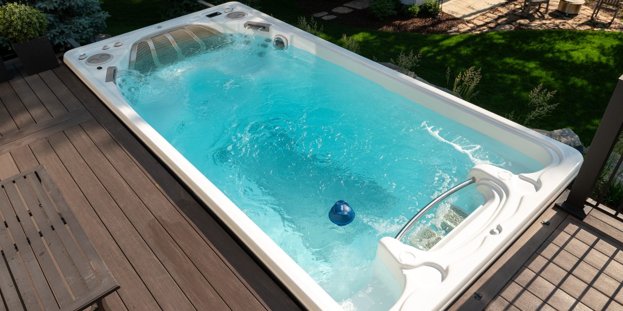 an overhead shot of a sparkling swim spa with a FROG @ease for Swim Spas floating in the water