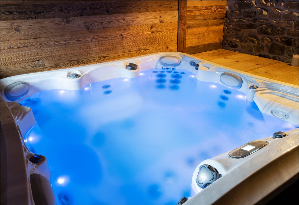 Overhead shot of a cloudy hot tub with blue lights on