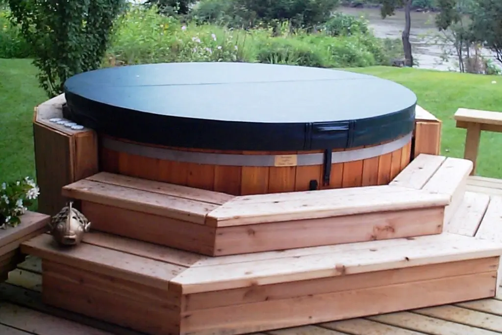 A hot tub cover fits snugly on an outdoor wooden hot tub